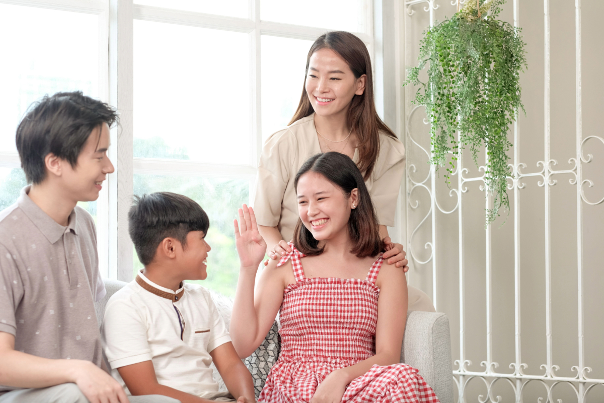 Asian family communicating in sign language.