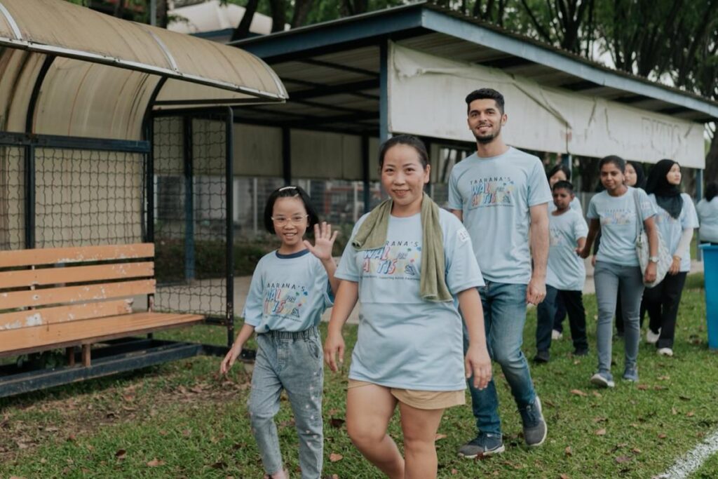 A group of people walking during an autism awareness event