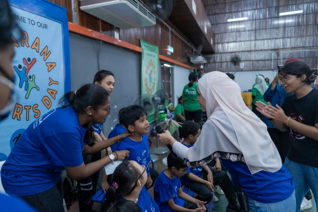 A student in blue cheer for his team during Taarana Sports Day