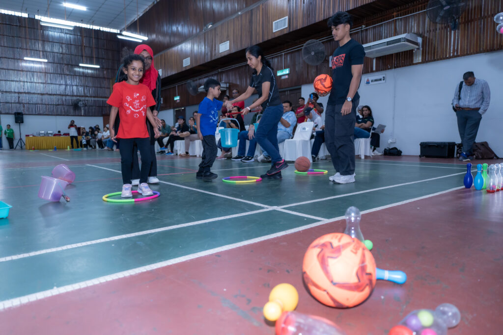 A girl smiling after throwing the ball during Taarana Sports Day