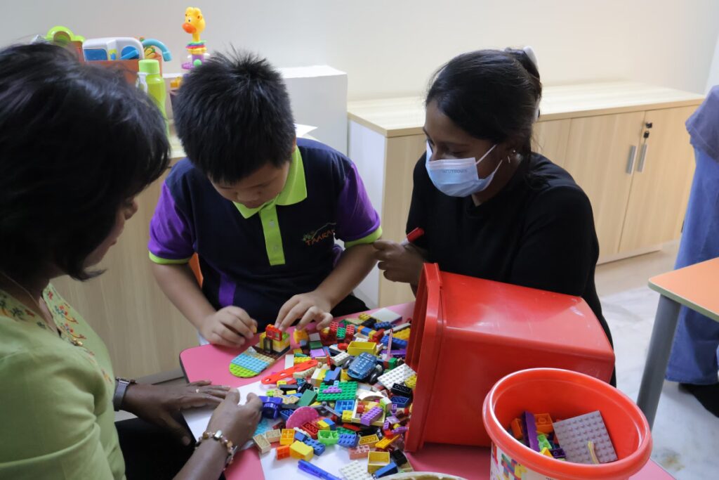 A kid playing lego