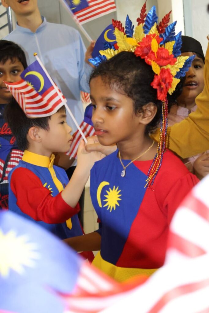 A kid wearing merdeka dress