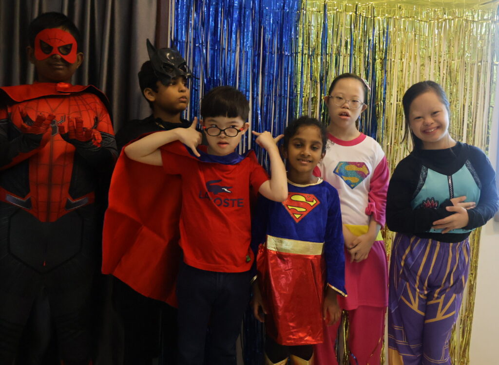 Student post together while wearing superhero outfit